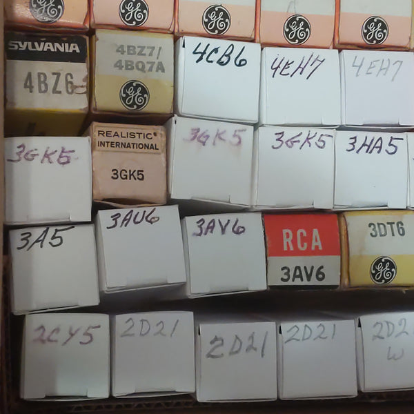 Stack of electronic component boxes with various brand labels on a shelf.
